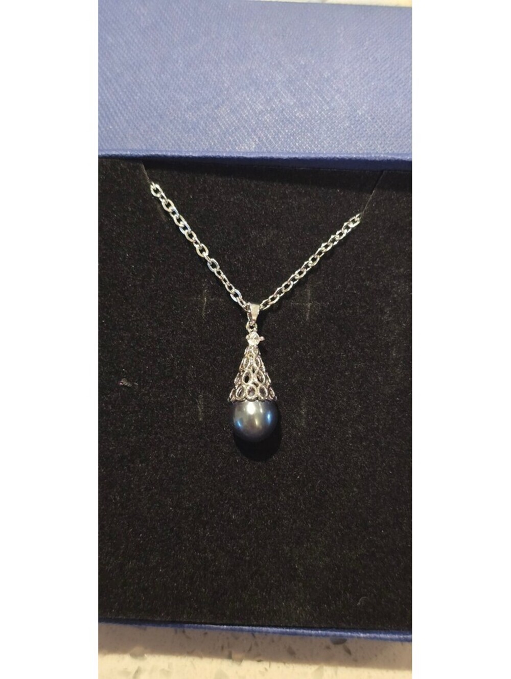 New, never worn, Natural Black Pearl set in 18" Stainless Steel chain.